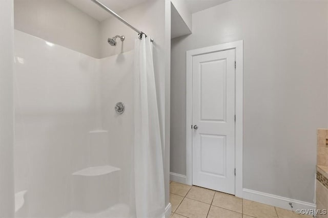 full bath with tile patterned floors, baseboards, and curtained shower