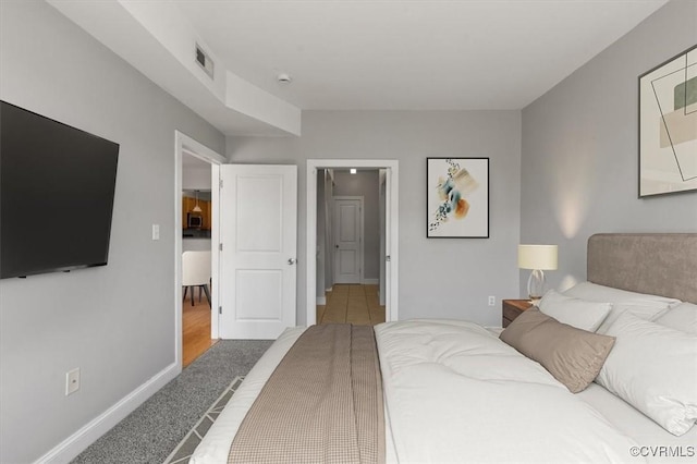bedroom featuring carpet and baseboards