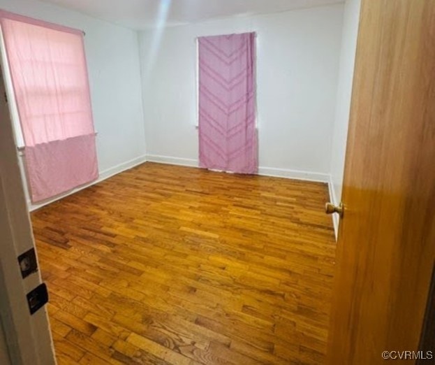 705 Endly St, Chase City, VA 23924 - empty room with wood finished floors and baseboards