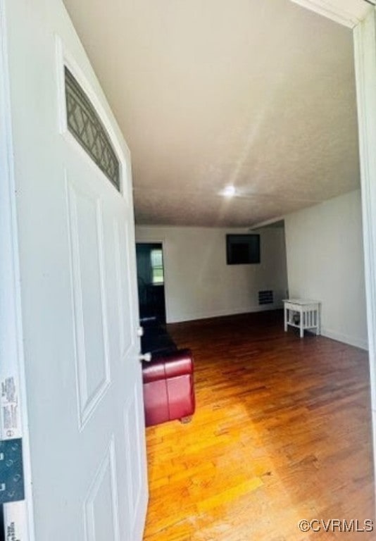 705 Endly St, Chase City, VA 23924 - unfurnished living room with wood finished floors and baseboards