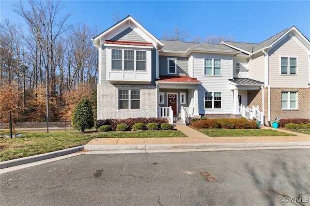 9475 Creek Summit Cir, Richmond, VA 23235 - view of property featuring a standing seam roof, brick siding, fence, and metal roof