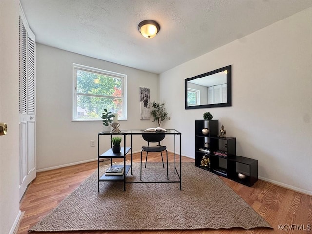 office area with wood finished floors and baseboards