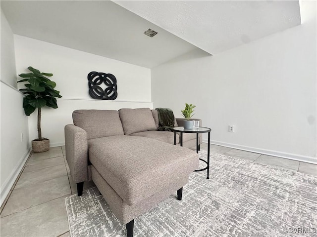 living room with light tile patterned floors and baseboards