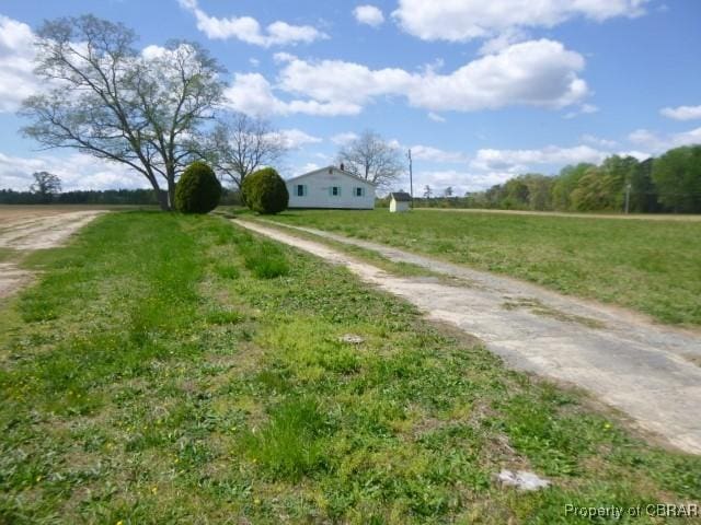 view of dirt / gravel road featuring a rural view