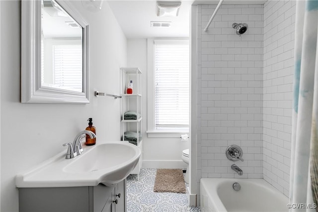 full bathroom featuring toilet, tile patterned flooring, vanity, shower / bath combo with shower curtain, and baseboards