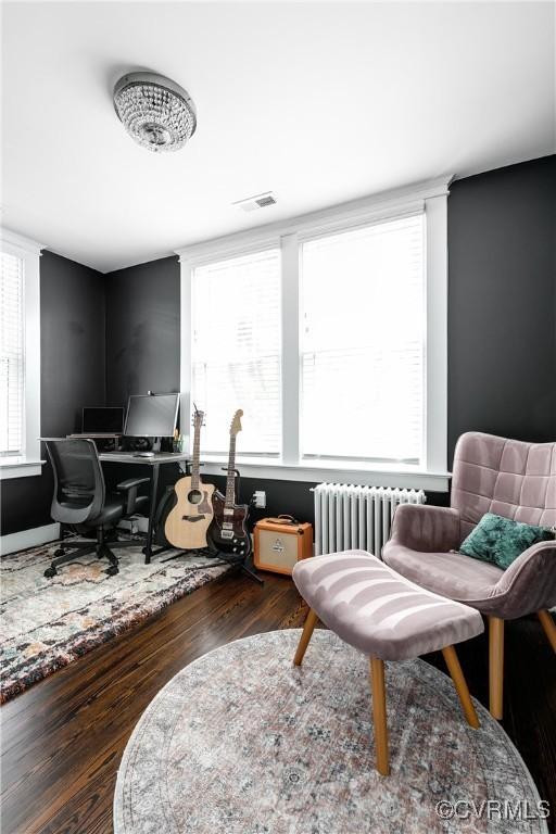 office area featuring radiator, wood finished floors, and plenty of natural light