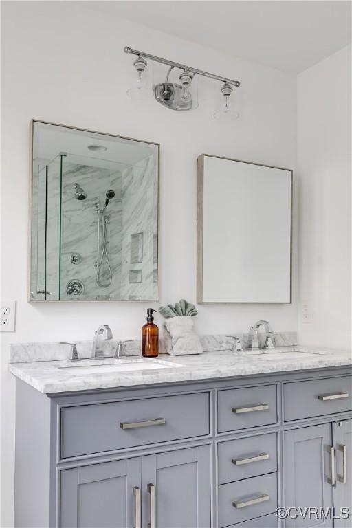 full bath with walk in shower and double vanity