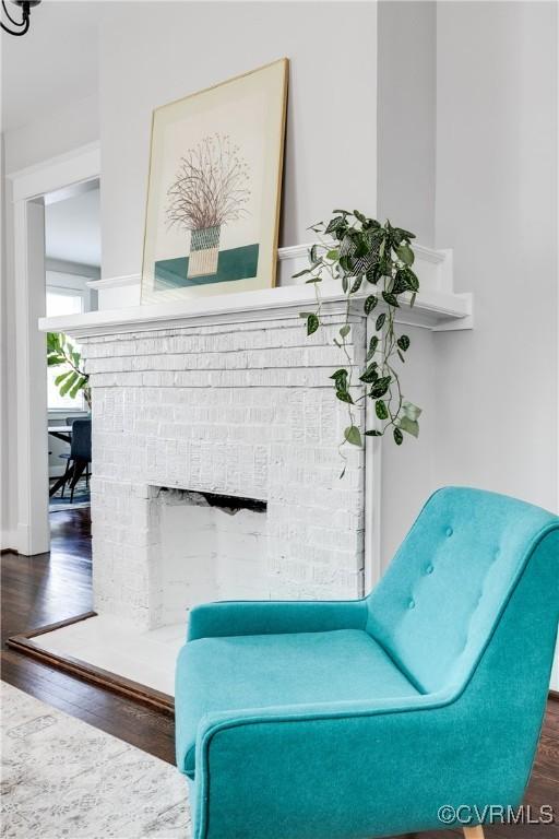 living area featuring wood finished floors and a fireplace