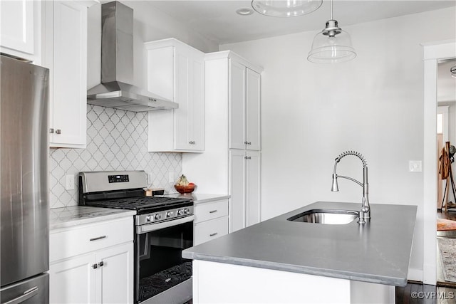 kitchen featuring appliances with stainless steel finishes, wall chimney exhaust hood, a sink, decorative backsplash, and white cabinetry