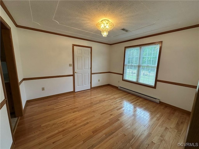 empty room featuring baseboard heating, light wood finished floors, a textured ceiling, a chandelier, and baseboards