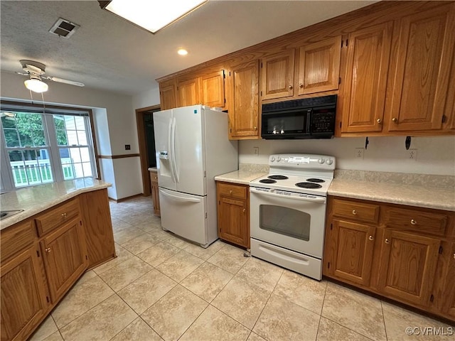 kitchen with white appliances, brown cabinets, light countertops, and recessed lighting