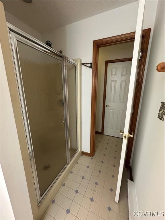 bathroom featuring a stall shower and tile patterned floors