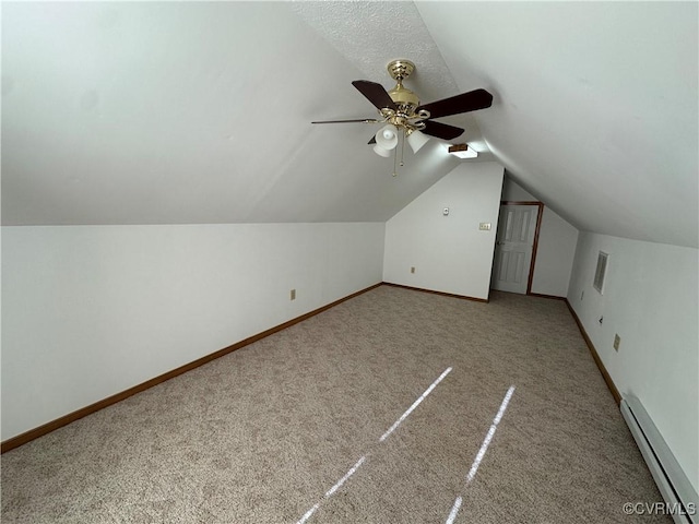 bonus room featuring a baseboard heating unit, carpet floors, lofted ceiling, and ceiling fan