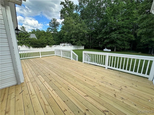 deck featuring view of wooded area