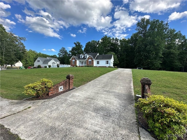 view of front of home with a front lawn and concrete driveway