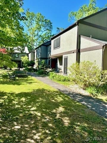 view of side of home with a yard