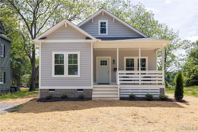 view of front facade featuring crawl space, a porch, and central AC unit