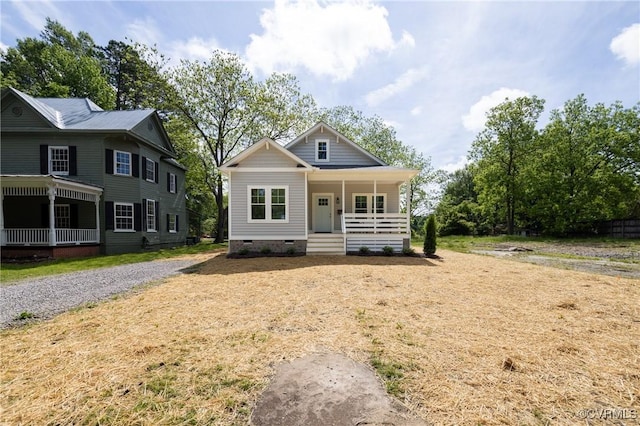 view of front of house featuring covered porch and crawl space