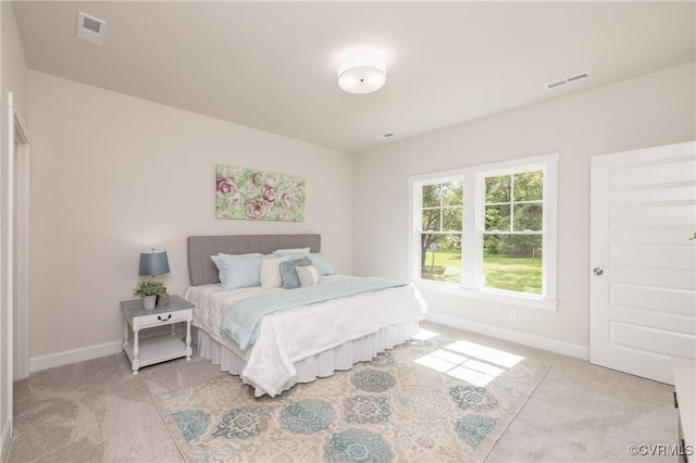 bedroom featuring light colored carpet and baseboards