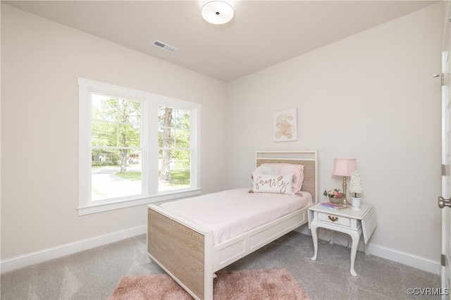 bedroom featuring baseboards and carpet