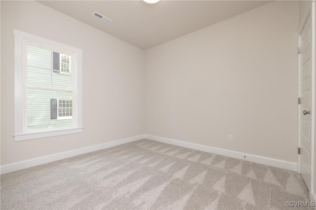 empty room with light colored carpet and baseboards