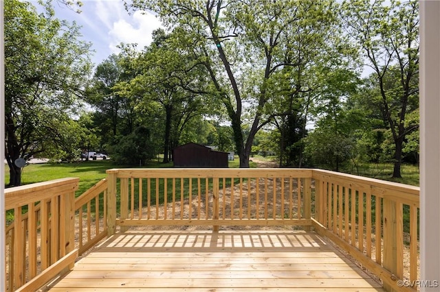 deck featuring view of wooded area