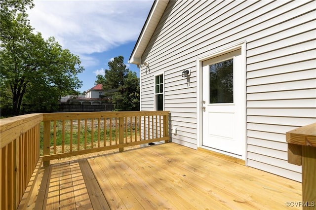 wooden terrace featuring fence