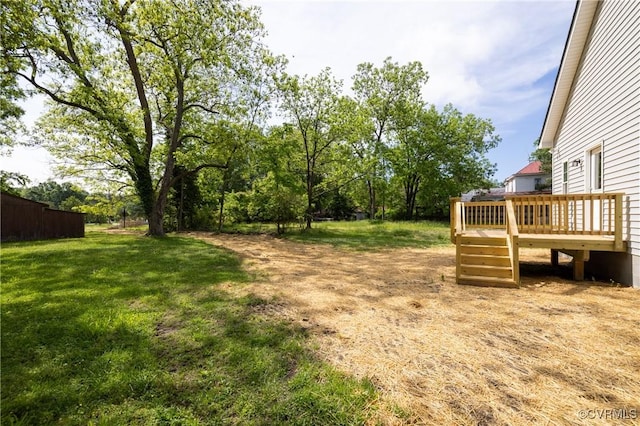view of green lawn featuring a deck