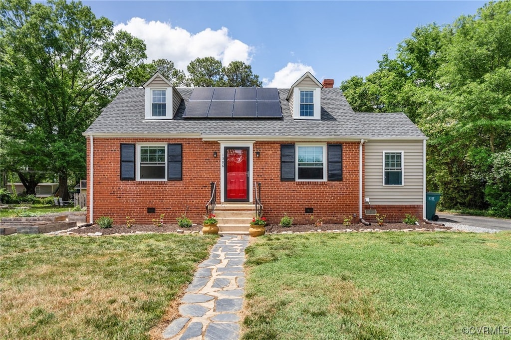 cape cod house with solar panels, a front lawn, crawl space, and roof with shingles