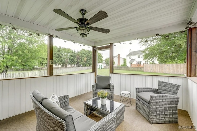 sunroom / solarium featuring ceiling fan and an outdoor hangout area