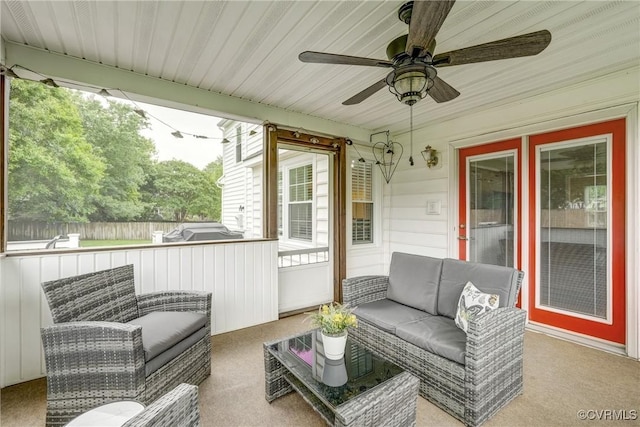 sunroom with healthy amount of natural light, a ceiling fan, and outdoor lounge area