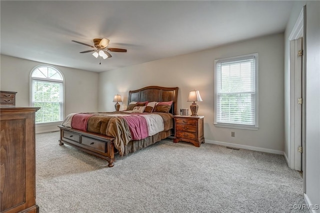 carpeted bedroom featuring baseboards and a ceiling fan