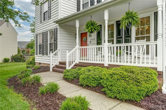 view of exterior entry with covered porch