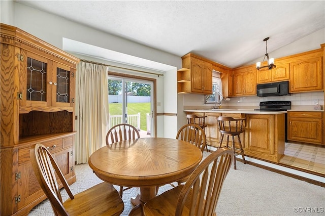 dining room with light carpet and lofted ceiling