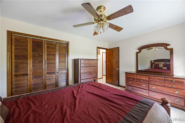 carpeted bedroom featuring a closet and ceiling fan