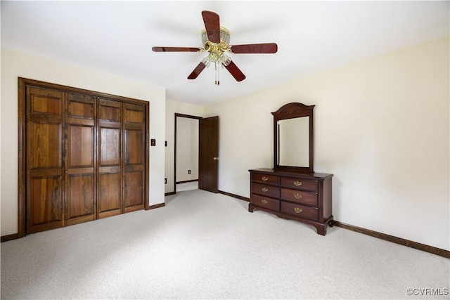 unfurnished bedroom featuring light carpet, baseboards, and ceiling fan