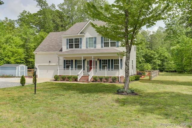 view of front of property with covered porch, a storage shed, driveway, a front lawn, and an outbuilding