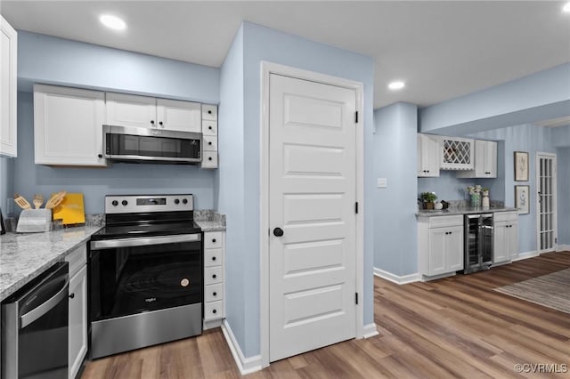 13130 The Glebe Ln, Charles City, VA 23030 - kitchen with stainless steel appliances, wine cooler, white cabinets, light wood-type flooring, and recessed lighting