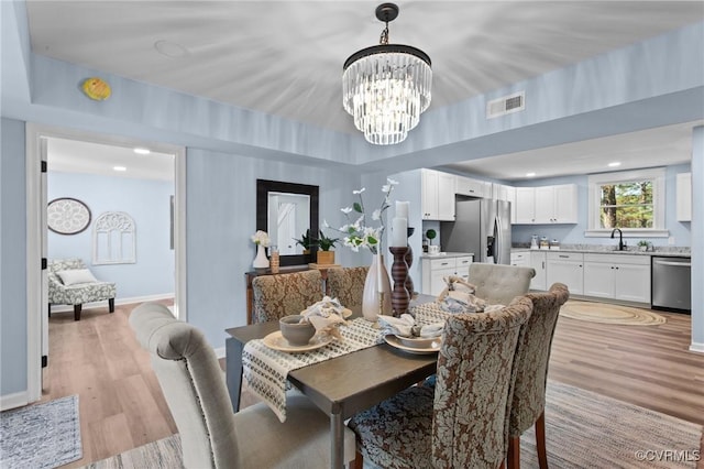 13130 The Glebe Ln, Charles City, VA 23030 - dining space with light wood-type flooring, a chandelier, and baseboards