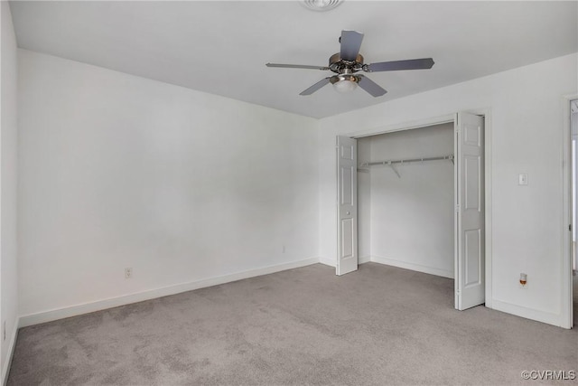 unfurnished bedroom featuring carpet floors, baseboards, a closet, and a ceiling fan