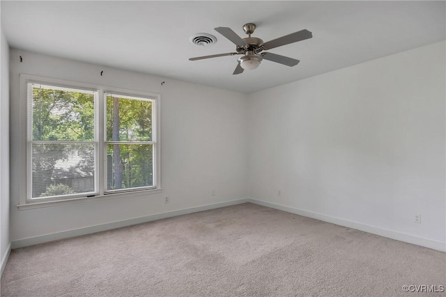 empty room with light carpet, baseboards, and a ceiling fan
