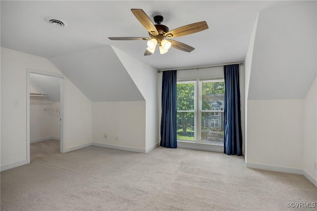 bonus room featuring carpet, vaulted ceiling, baseboards, and ceiling fan