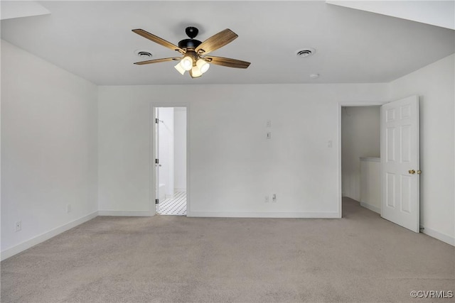 unfurnished bedroom featuring light colored carpet, baseboards, and ceiling fan