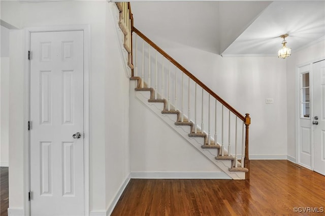 entrance foyer with wood finished floors, stairway, baseboards, and crown molding