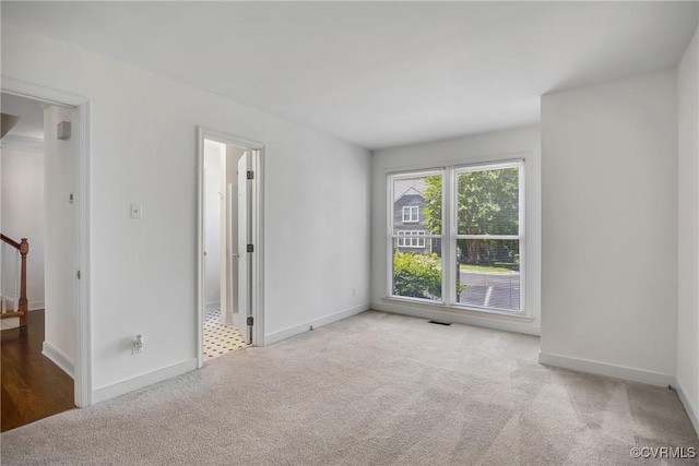 carpeted spare room with baseboards