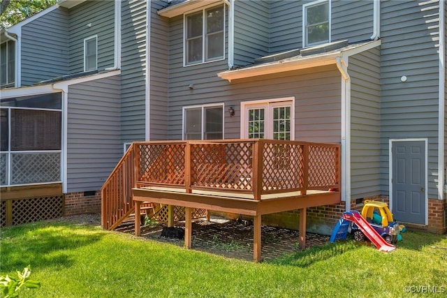 back of house with a deck and a yard