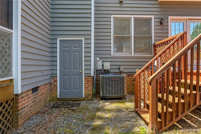 doorway to property featuring central air condition unit and crawl space