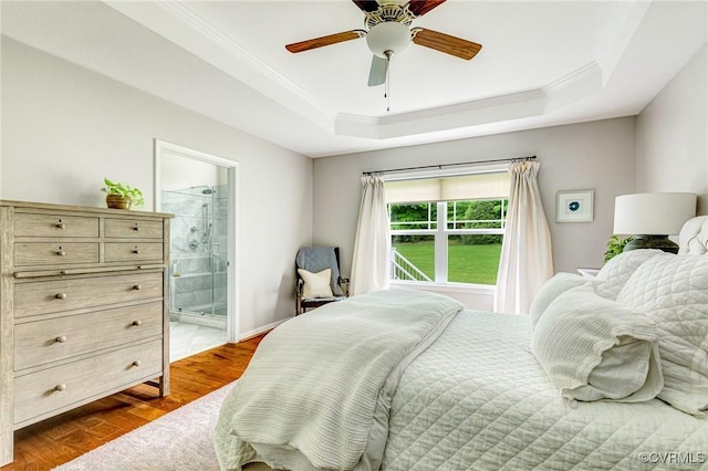10527 Deerlake Dr, New Kent, VA 23124 - bedroom featuring a tray ceiling, ornamental molding, dark wood-type flooring, ensuite bath, and a ceiling fan