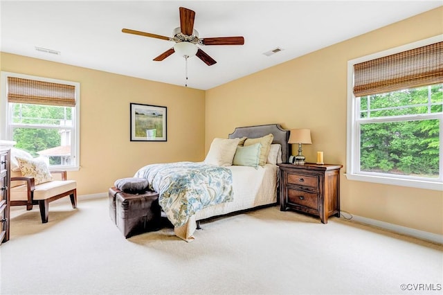 10527 Deerlake Dr, New Kent, VA 23124 - bedroom featuring light carpet, multiple windows, baseboards, and a ceiling fan