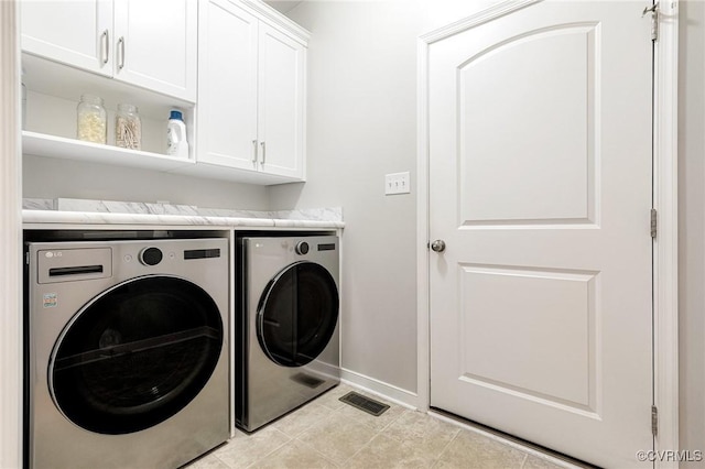 10527 Deerlake Dr, New Kent, VA 23124 - laundry room featuring cabinet space, washer and clothes dryer, baseboards, and light tile patterned floors